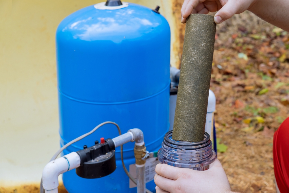 Someone performing maintenance on their water filter.