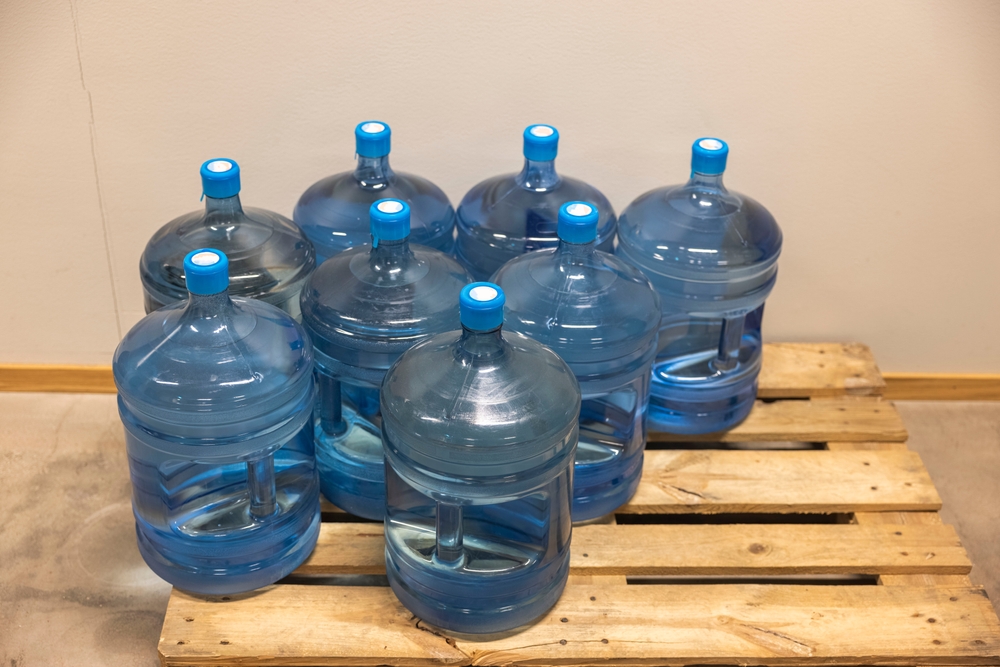 Jugs of water on a pallet.