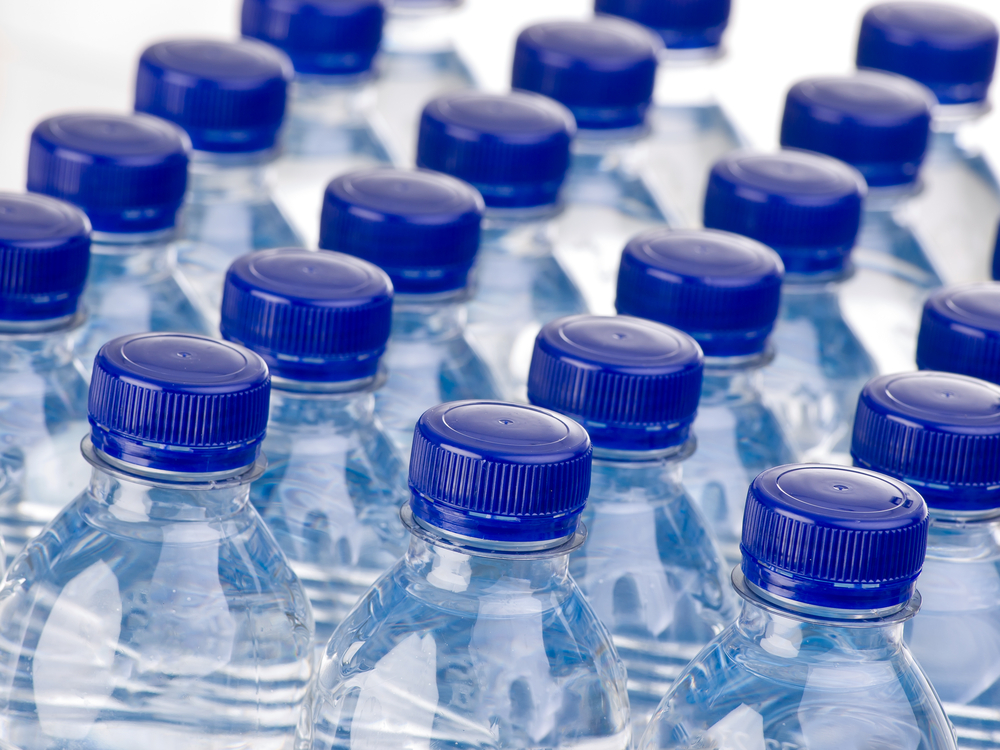 A closeup of rows of bottled water.